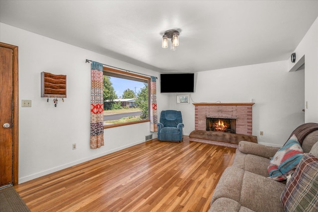 7616 E Baldwin Ave, Spokane, WA 99212 - living area featuring light wood-type flooring and a brick fireplace