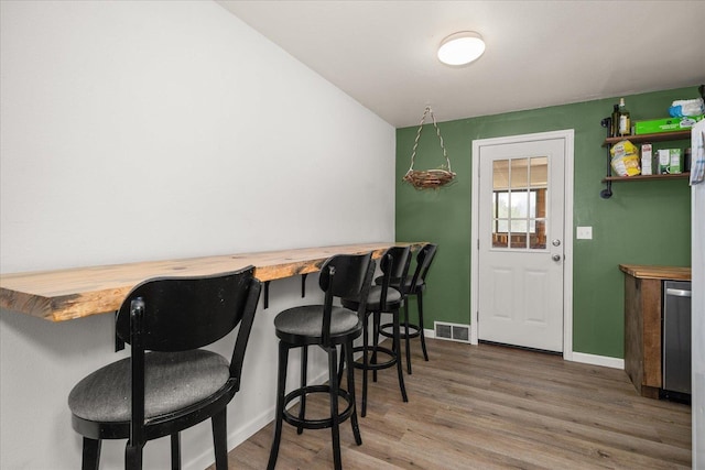 7616 E Baldwin Ave, Spokane, WA 99212 - dining space featuring wood finished floors and a dry bar
