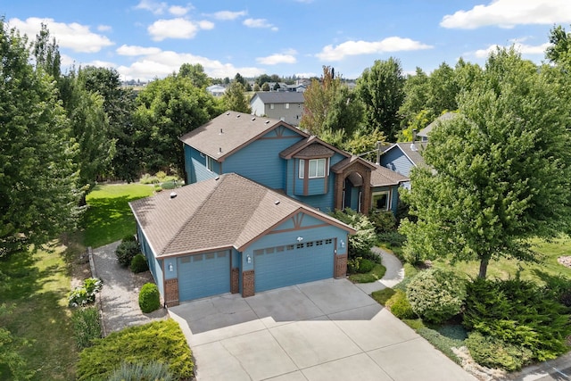 9617 N Northview Ln, Spokane, WA 99208 - view of front of house featuring brick siding, a garage, driveway, and roof with shingles