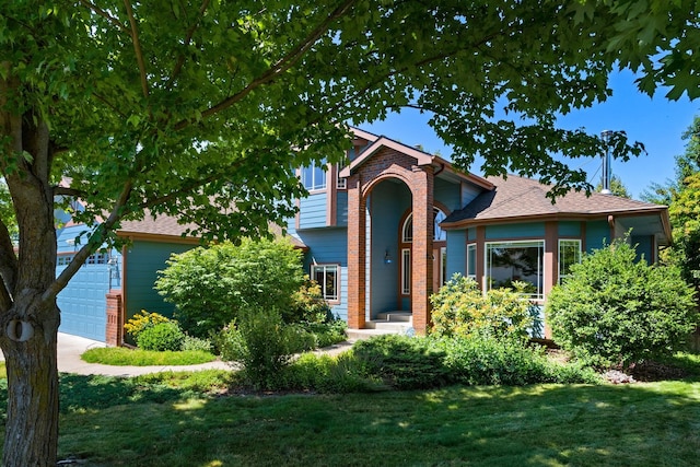 9617 N Northview Ln, Spokane, WA 99208 - view of front facade featuring a front yard, a garage, concrete driveway, a shingled roof, and brick siding