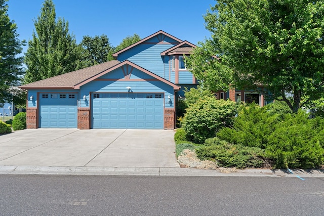 9617 N Northview Ln, Spokane, WA 99208 - view of front of house with brick siding, a garage, and driveway
