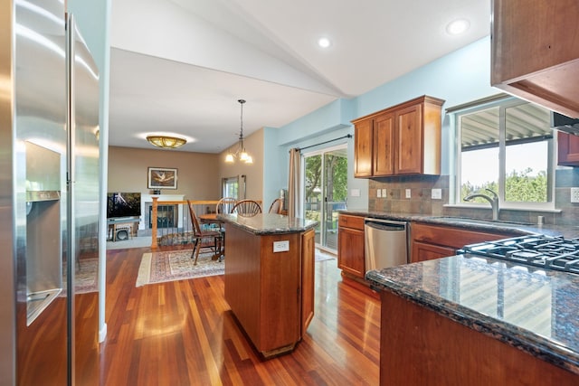 9617 N Northview Ln, Spokane, WA 99208 - kitchen with stainless steel appliances, dark wood-type flooring, brown cabinets, backsplash, and lofted ceiling