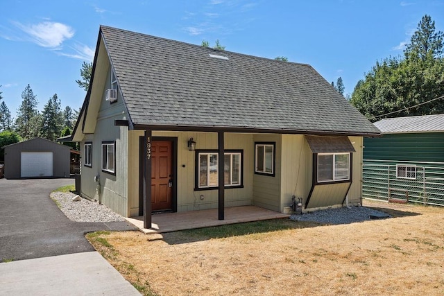 1937 W 15th Ave, Spokane, WA 99224 - rear view of property featuring roof with shingles, an outbuilding, a detached garage, a porch, and driveway
