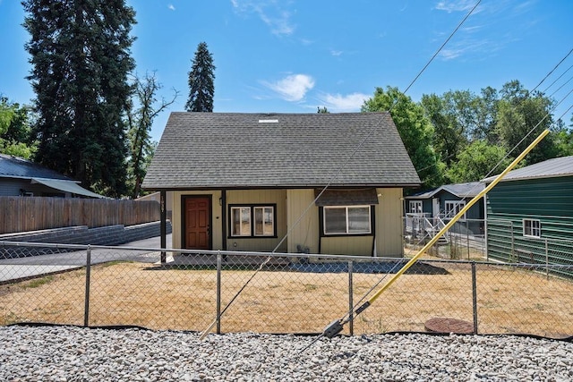 1937 W 15th Ave, Spokane, WA 99224 - view of front facade with a shingled roof and a fenced front yard