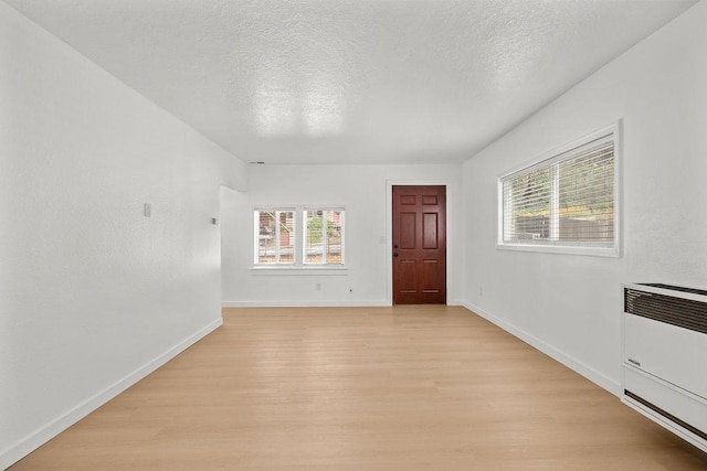1937 W 15th Ave, Spokane, WA 99224 - foyer featuring light wood-type flooring, a textured ceiling, and heating unit