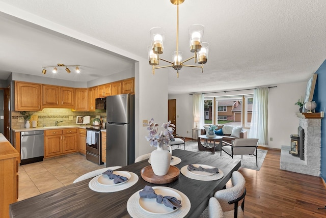 201 W Barnes Rd, Spokane, WA 99218 - dining room with a chandelier, a textured ceiling, and light wood finished floors