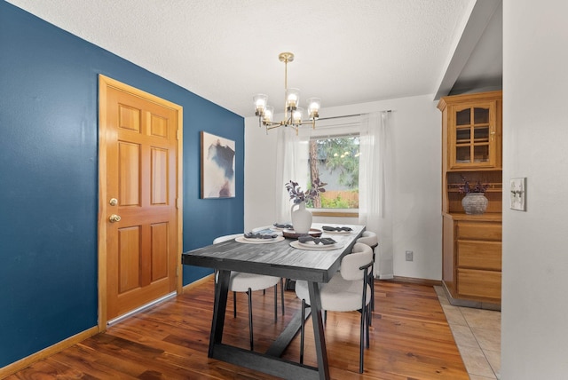 201 W Barnes Rd, Spokane, WA 99218 - dining space with a chandelier, wood finished floors, and a textured ceiling