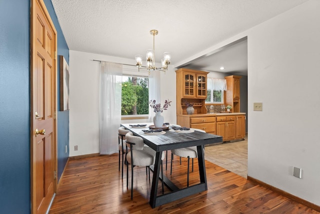 201 W Barnes Rd, Spokane, WA 99218 - dining space featuring a chandelier, wood finished floors, and a textured ceiling