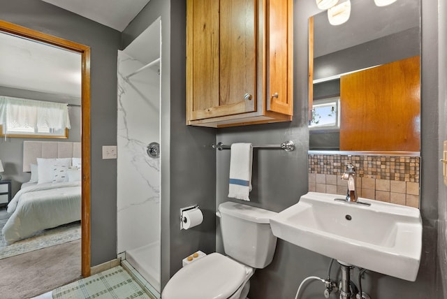 201 W Barnes Rd, Spokane, WA 99218 - bathroom featuring a shower stall, ensuite bath, and tasteful backsplash