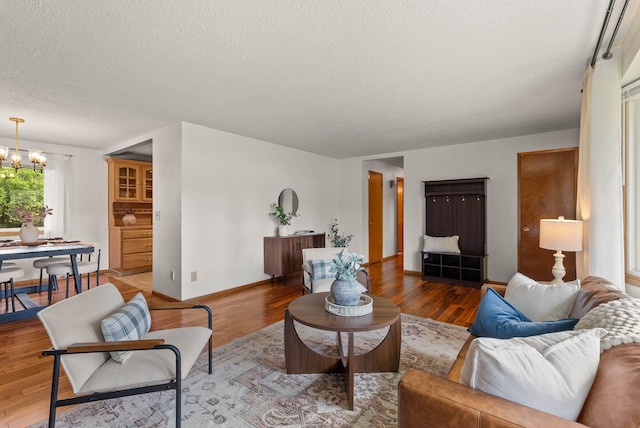201 W Barnes Rd, Spokane, WA 99218 - living room with a chandelier, a textured ceiling, and wood finished floors