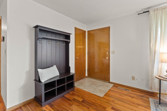 201 W Barnes Rd, Spokane, WA 99218 - mudroom with wood finished floors and a textured ceiling