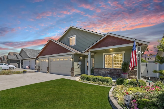 3316 N Coleman St, Post Falls, ID 83854 - view of front of home with an attached garage, driveway, stone siding, and covered porch