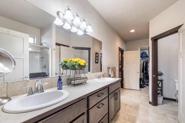 3316 N Coleman St, Post Falls, ID 83854 - full bathroom featuring a stall shower, double vanity, a spacious closet, and recessed lighting