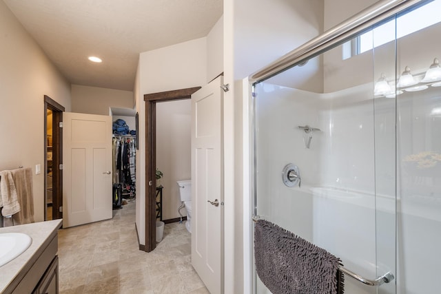 3316 N Coleman St, Post Falls, ID 83854 - bathroom with a stall shower, vanity, recessed lighting, and a walk in closet