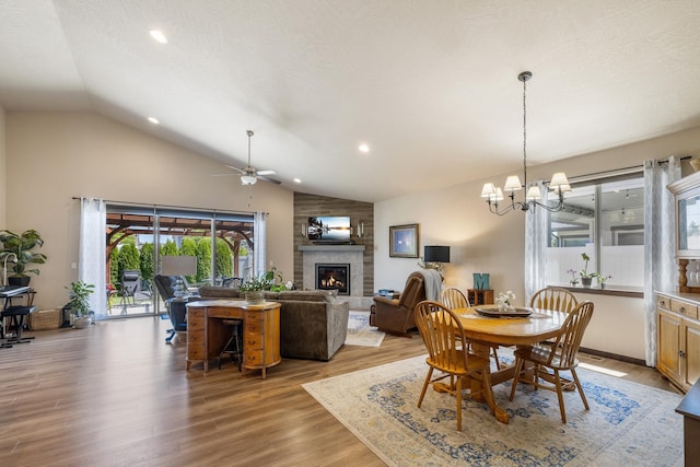 3316 N Coleman St, Post Falls, ID 83854 - dining area with a large fireplace, a ceiling fan, a chandelier, light wood finished floors, and recessed lighting