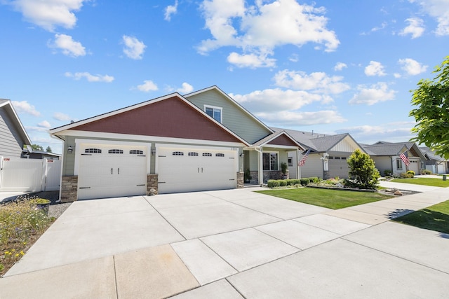 3316 N Coleman St, Post Falls, ID 83854 - craftsman inspired home with stone siding, a garage, and driveway