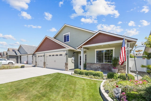 3316 N Coleman St, Post Falls, ID 83854 - view of front of property with driveway, a garage, stone siding, and a porch