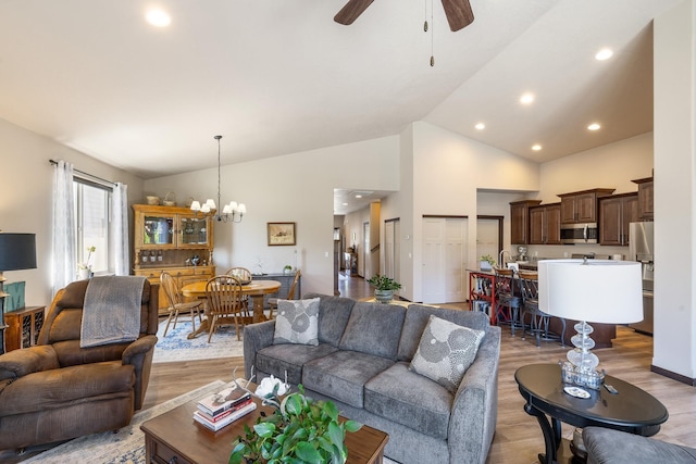 3316 N Coleman St, Post Falls, ID 83854 - living area with light wood-type flooring, a chandelier, ceiling fan, high vaulted ceiling, and recessed lighting