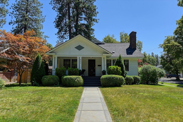 927 W 19th Ave, Spokane, WA 99203 - view of front of property with covered porch, a chimney, and a front lawn