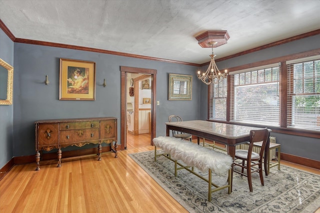 927 W 19th Ave, Spokane, WA 99203 - dining area featuring a chandelier, light wood-type flooring, and crown molding