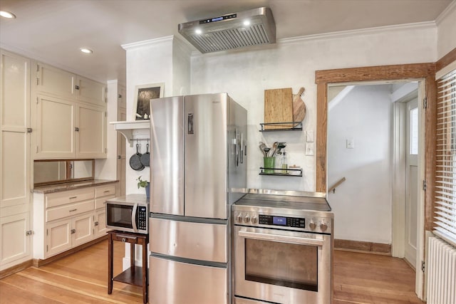 927 W 19th Ave, Spokane, WA 99203 - kitchen featuring appliances with stainless steel finishes, crown molding, light wood-type flooring, ventilation hood, and radiator heating unit