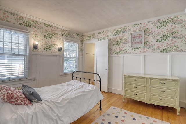 927 W 19th Ave, Spokane, WA 99203 - bedroom featuring crown molding, wallpapered walls, a wainscoted wall, light wood-type flooring, and a decorative wall