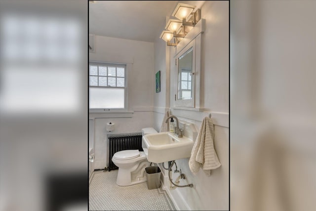 927 W 19th Ave, Spokane, WA 99203 - half bath featuring radiator heating unit and tile patterned floors