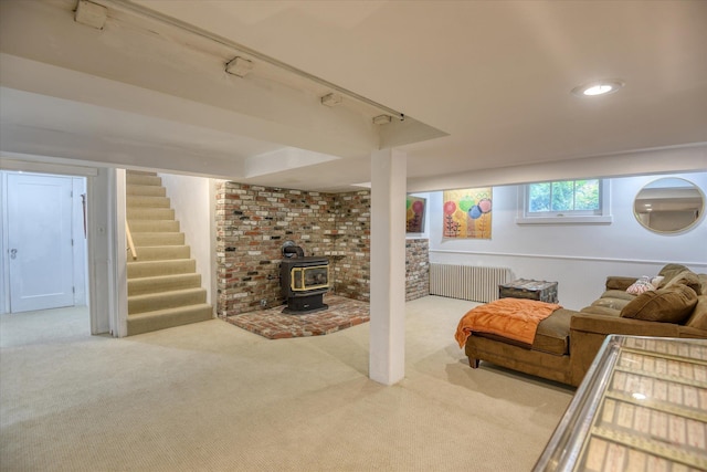 927 W 19th Ave, Spokane, WA 99203 - living area with radiator heating unit, carpet, stairway, a wood stove, and recessed lighting