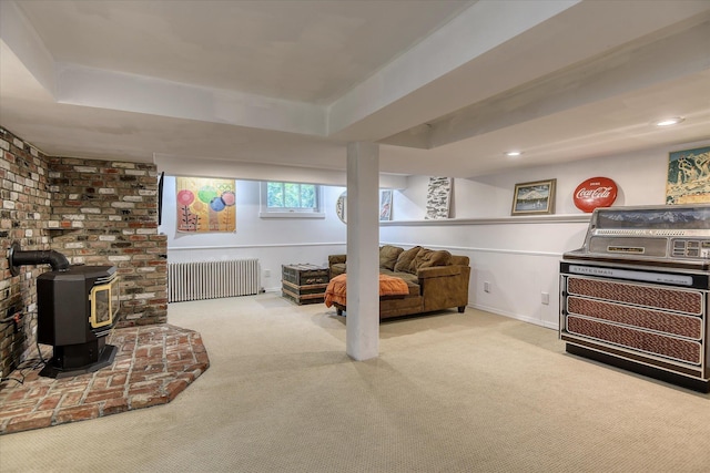 927 W 19th Ave, Spokane, WA 99203 - carpeted living area featuring radiator heating unit, a tray ceiling, a wood stove, and recessed lighting