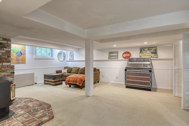 927 W 19th Ave, Spokane, WA 99203 - living area with radiator heating unit, carpet floors, a wood stove, and recessed lighting