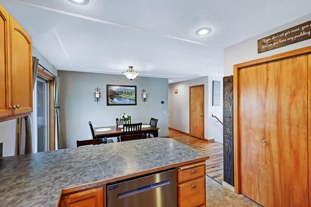 11606 E 8th Ave, Spokane Valley, WA 99206 - kitchen with dishwasher, brown cabinetry, recessed lighting, a peninsula, and dark countertops