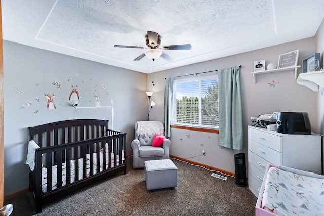 11606 E 8th Ave, Spokane Valley, WA 99206 - carpeted bedroom featuring a crib, a textured ceiling, and a ceiling fan