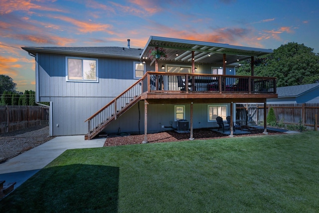 11606 E 8th Ave, Spokane Valley, WA 99206 - back of house at dusk featuring stairway, a deck, and a fenced backyard