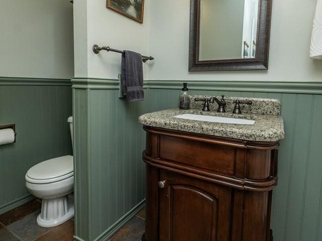 10108 E 19th Ave, Spokane Valley, WA 99206 - half bathroom featuring a wainscoted wall, vanity, and a decorative wall