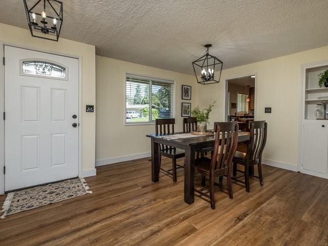 10108 E 19th Ave, Spokane Valley, WA 99206 - dining area featuring a chandelier, wood finished floors, and a textured ceiling