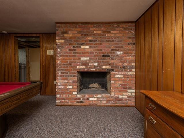 10108 E 19th Ave, Spokane Valley, WA 99206 - living room featuring wooden walls, a brick fireplace, carpet floors, and billiards