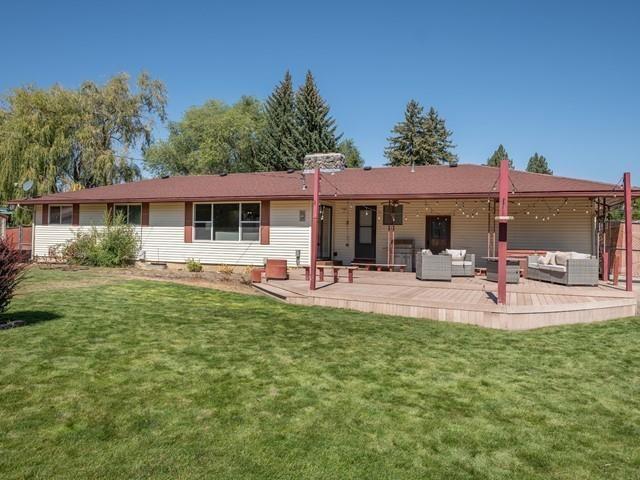 10108 E 19th Ave, Spokane Valley, WA 99206 - back of property with an outdoor living space and a lawn