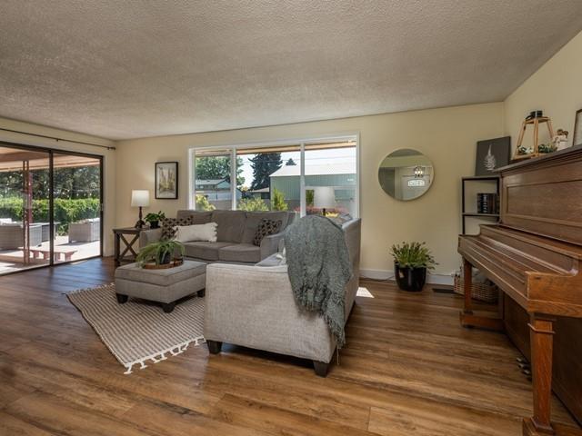 10108 E 19th Ave, Spokane Valley, WA 99206 - living area with a textured ceiling and wood finished floors