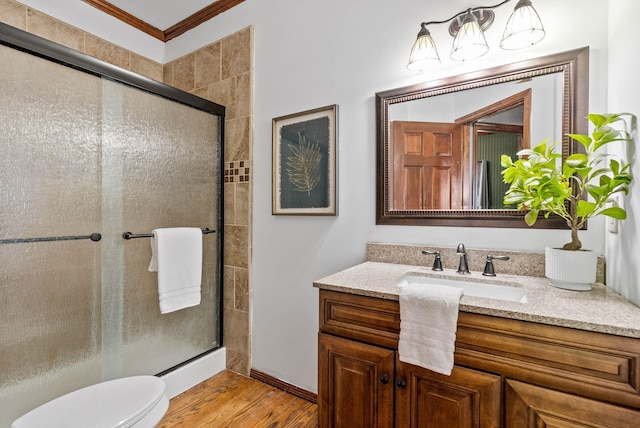 6204 E Custer Ln, Spokane, WA 99223 - bathroom featuring vanity, a tile shower, wood finished floors, and crown molding