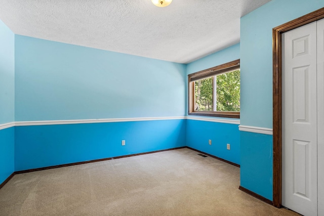 6204 E Custer Ln, Spokane, WA 99223 - empty room featuring carpet flooring and a textured ceiling