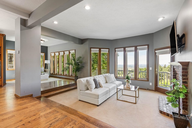 6204 E Custer Ln, Spokane, WA 99223 - living room with recessed lighting, light wood-type flooring, beam ceiling, and a fireplace