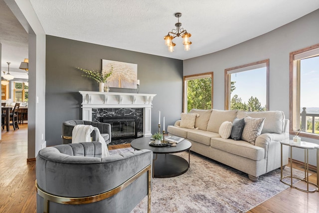 6204 E Custer Ln, Spokane, WA 99223 - living area featuring wood finished floors, a high end fireplace, and a chandelier