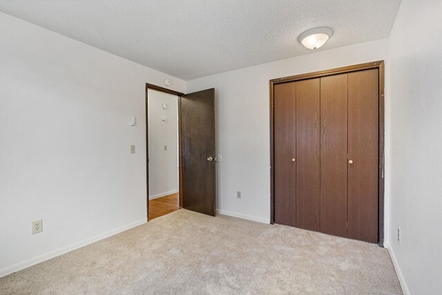 6125 N Addison St, Spokane, WA 99208 - unfurnished bedroom with carpet floors, a textured ceiling, and a closet