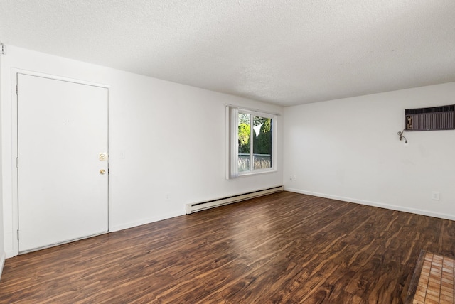 6125 N Addison St, Spokane, WA 99208 - spare room featuring a baseboard heating unit, an AC wall unit, wood finished floors, and a textured ceiling