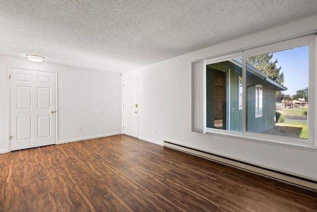 6125 N Addison St, Spokane, WA 99208 - unfurnished room featuring baseboard heating, a textured ceiling, and wood finished floors