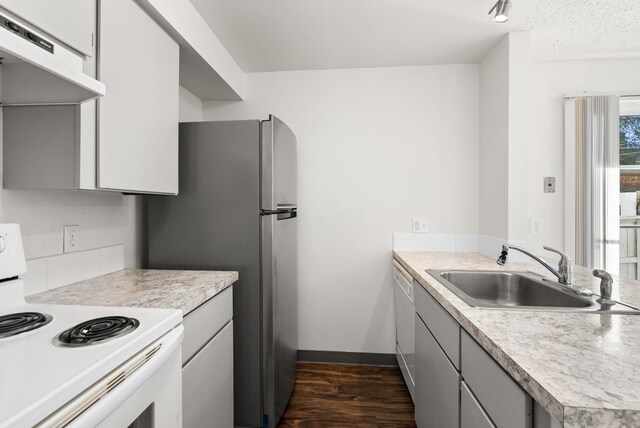 6125 N Addison St, Spokane, WA 99208 - kitchen featuring white appliances, under cabinet range hood, light countertops, and dark wood-type flooring