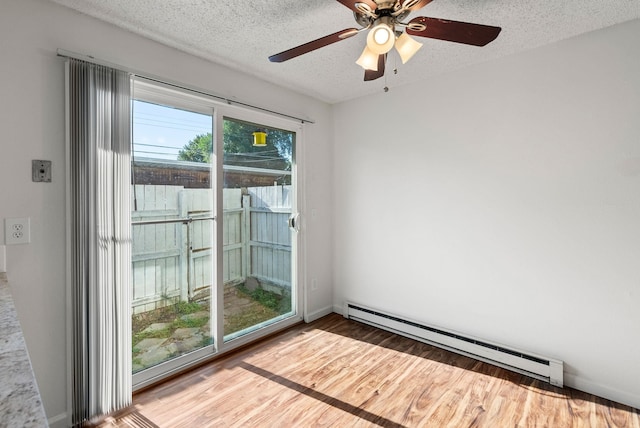 6125 N Addison St, Spokane, WA 99208 - empty room with a baseboard radiator, wood finished floors, a textured ceiling, and ceiling fan