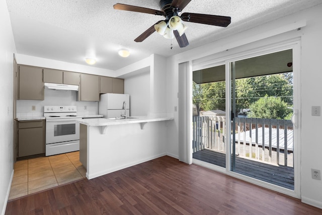 6125 N Addison St, Spokane, WA 99208 - kitchen featuring white appliances, gray cabinets, under cabinet range hood, a peninsula, and a textured ceiling