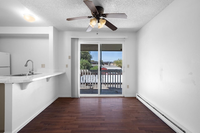 6125 N Addison St, Spokane, WA 99208 - unfurnished dining area with a baseboard radiator, a textured ceiling, wood finished floors, and a ceiling fan