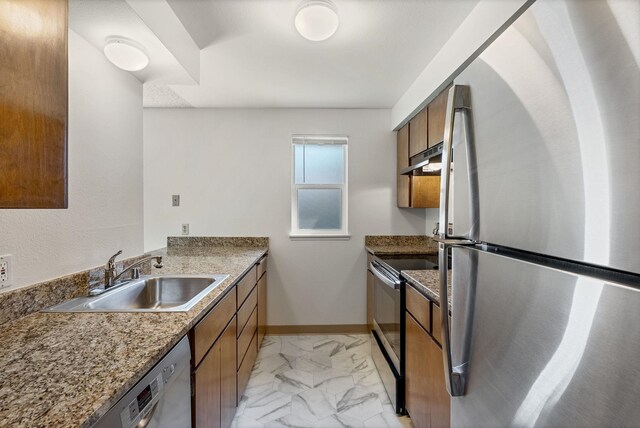 6125 N Addison St, Spokane, WA 99208 - kitchen featuring appliances with stainless steel finishes, brown cabinets, light marble finish floors, and under cabinet range hood